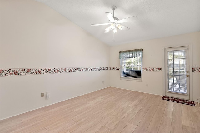 spare room featuring ceiling fan, light hardwood / wood-style floors, and a textured ceiling