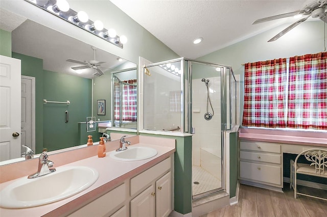 bathroom with hardwood / wood-style floors, vanity, walk in shower, and a textured ceiling