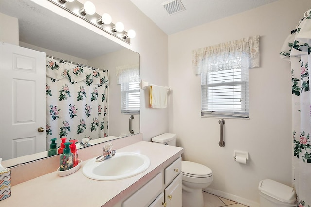 bathroom featuring tile patterned floors, vanity, curtained shower, and toilet