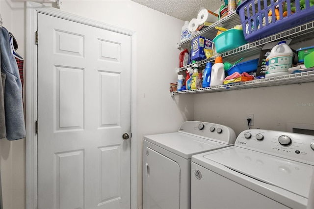 laundry area featuring separate washer and dryer and a textured ceiling