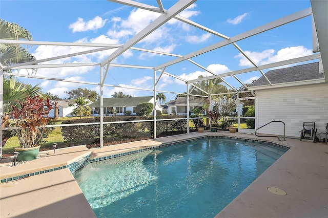 view of pool featuring glass enclosure and a patio area