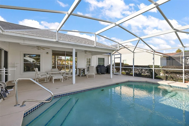 view of pool with a lanai, grilling area, ceiling fan, and a patio area