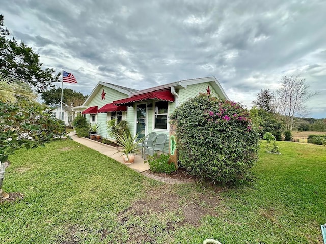 view of side of home with a lawn