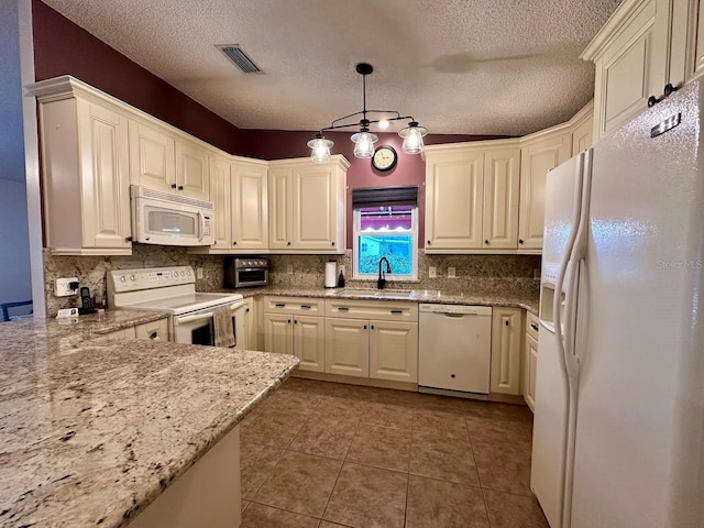 kitchen featuring sink, light stone counters, decorative light fixtures, white appliances, and light tile patterned floors