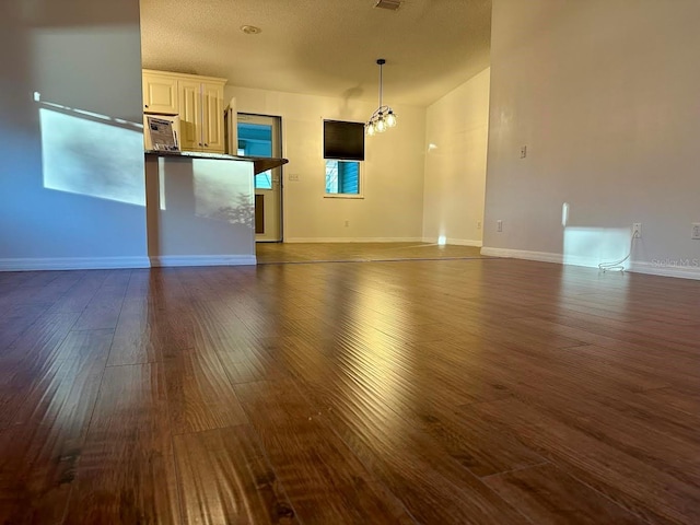 unfurnished living room with dark hardwood / wood-style flooring