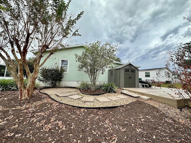 view of property exterior featuring a shed and a patio area