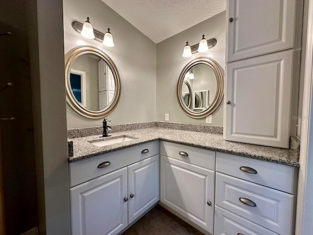 bathroom featuring vanity and a textured ceiling