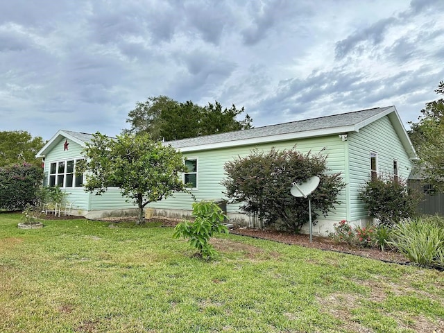 back of property featuring a lawn