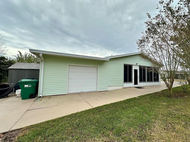 rear view of property with a yard and a garage