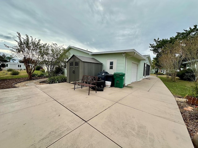 view of property exterior with a patio and a storage shed