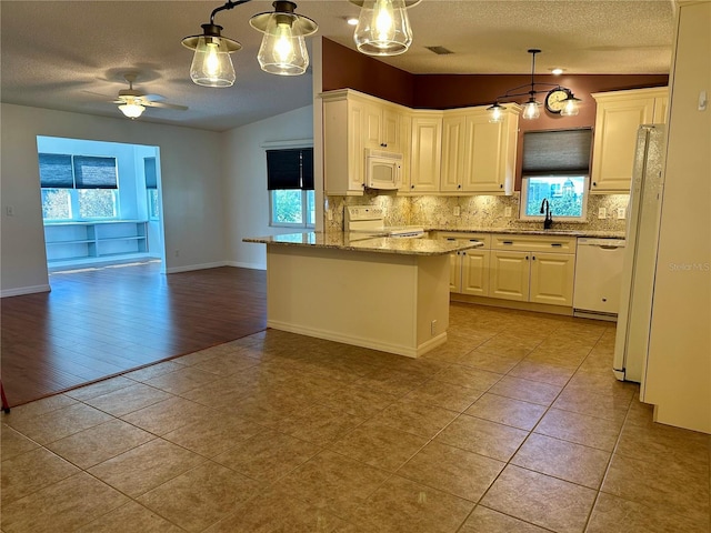 kitchen featuring hanging light fixtures, white cabinetry, light stone countertops, and white appliances