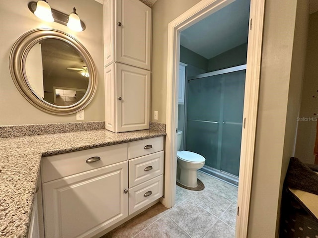 bathroom with walk in shower, vanity, toilet, and tile patterned flooring