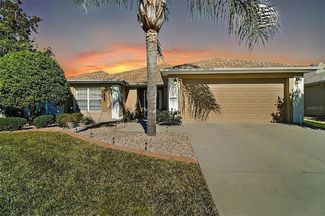 view of front of home featuring a lawn and a garage