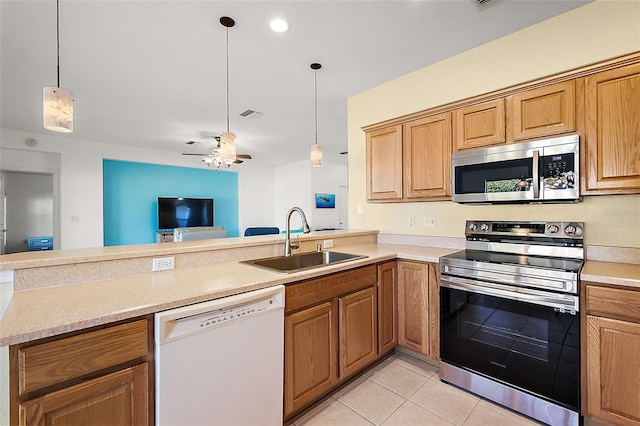 kitchen featuring ceiling fan, sink, decorative light fixtures, light tile patterned floors, and appliances with stainless steel finishes