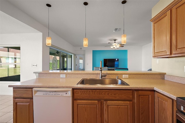 kitchen with white dishwasher, sink, ceiling fan, light tile patterned floors, and decorative light fixtures