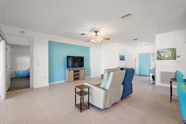 living room featuring ceiling fan and light tile patterned flooring