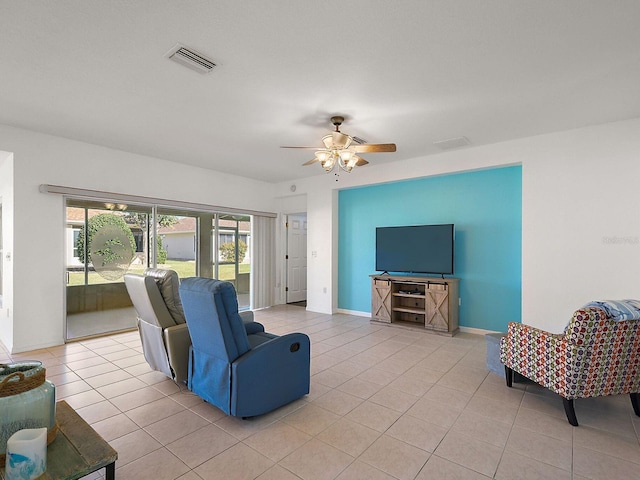 tiled living room with ceiling fan