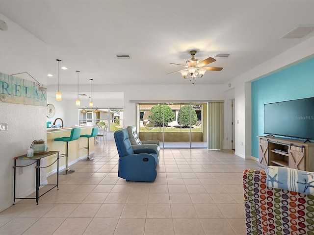 living room with light tile patterned floors and ceiling fan