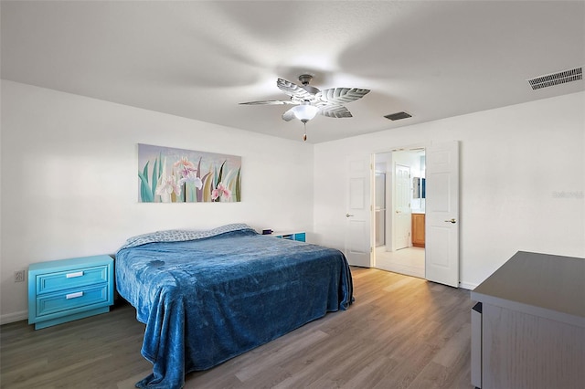 bedroom featuring connected bathroom, ceiling fan, and dark hardwood / wood-style floors