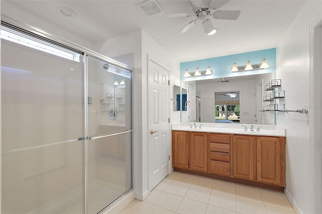 bathroom featuring tile patterned floors, vanity, ceiling fan, and a shower with door