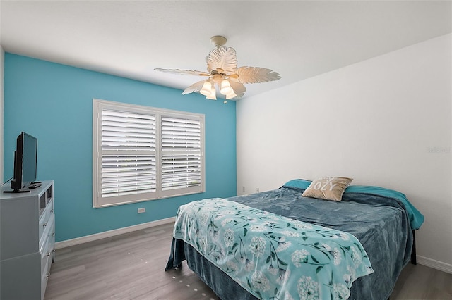 bedroom featuring wood-type flooring and ceiling fan