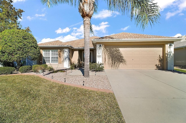 view of front of property featuring a front yard and a garage