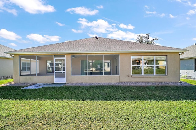 back of house with a sunroom and a yard