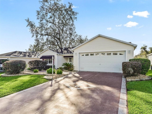 ranch-style home with a front lawn and a garage