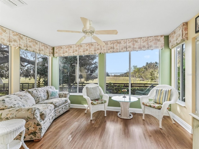 sunroom featuring ceiling fan