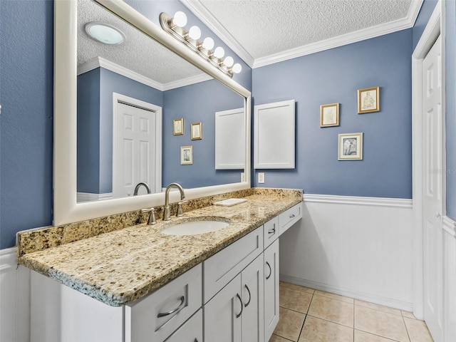 bathroom with a textured ceiling, crown molding, and tile patterned floors