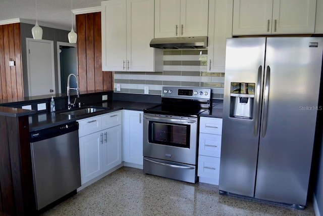 kitchen with appliances with stainless steel finishes, backsplash, sink, decorative light fixtures, and white cabinetry