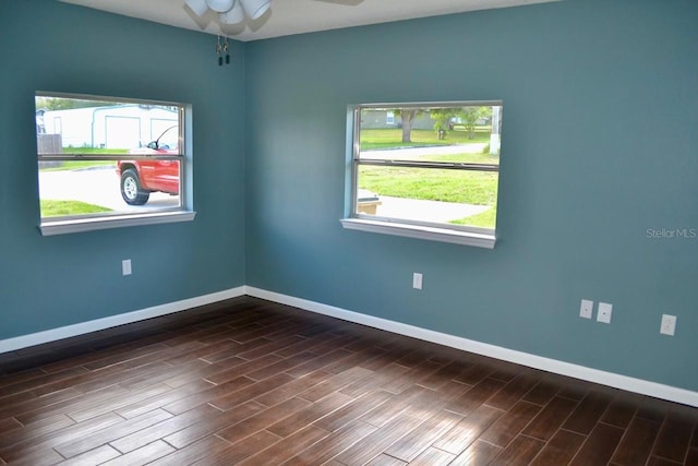 unfurnished room featuring ceiling fan and dark wood-type flooring