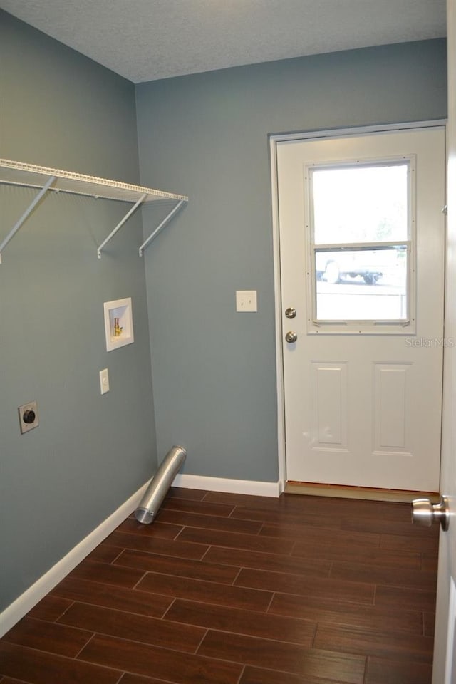 laundry area featuring electric dryer hookup, hookup for a washing machine, dark wood-type flooring, and a textured ceiling