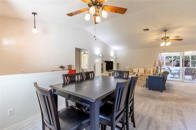 dining area with light colored carpet, ceiling fan, and lofted ceiling