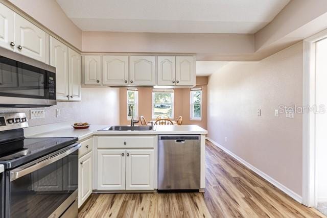 kitchen with white cabinets, sink, and stainless steel appliances