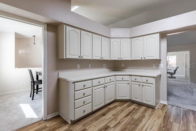 kitchen featuring light hardwood / wood-style floors and white cabinetry