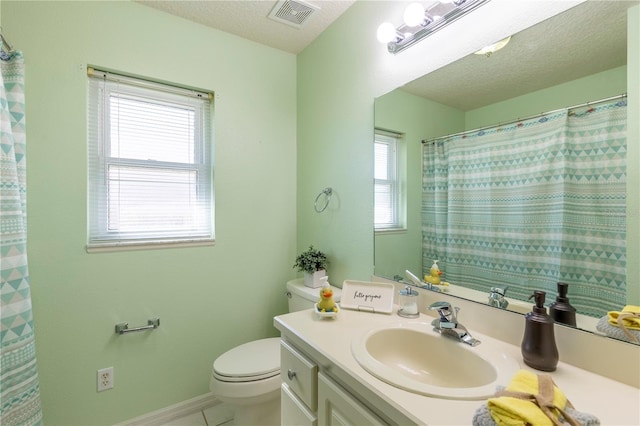 bathroom featuring vanity, a textured ceiling, toilet, and tile patterned flooring