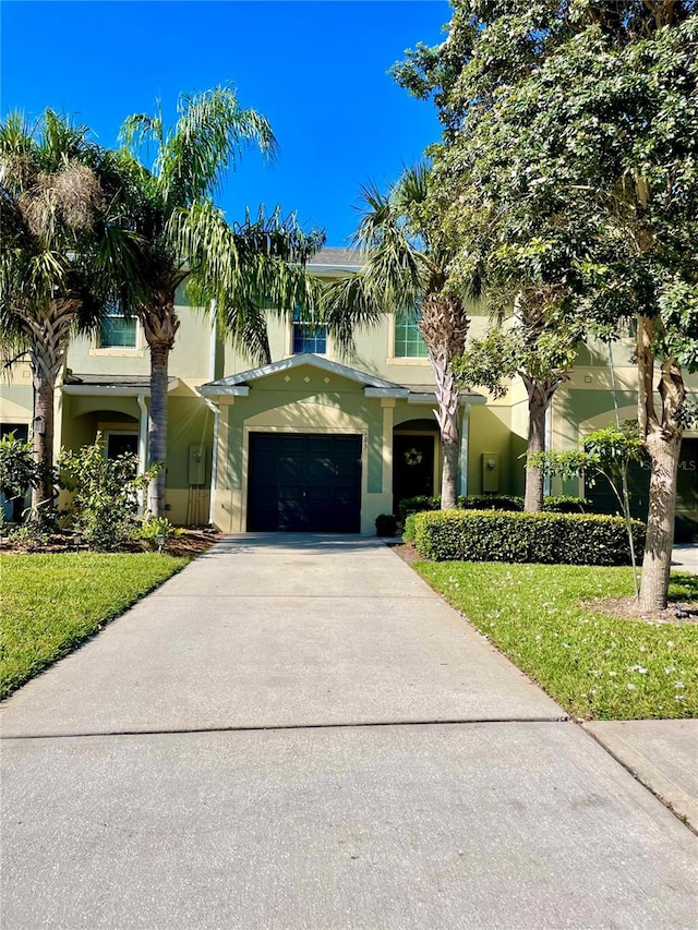 view of front of property with a front lawn and a garage