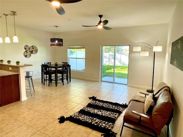 living room featuring ceiling fan and light tile patterned floors