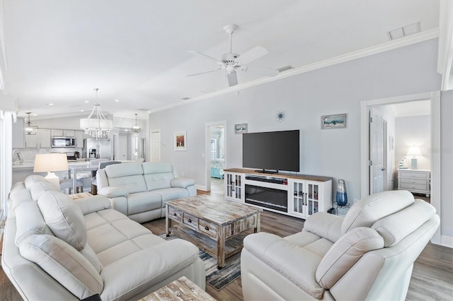 living room featuring crown molding, ceiling fan, and wood-type flooring