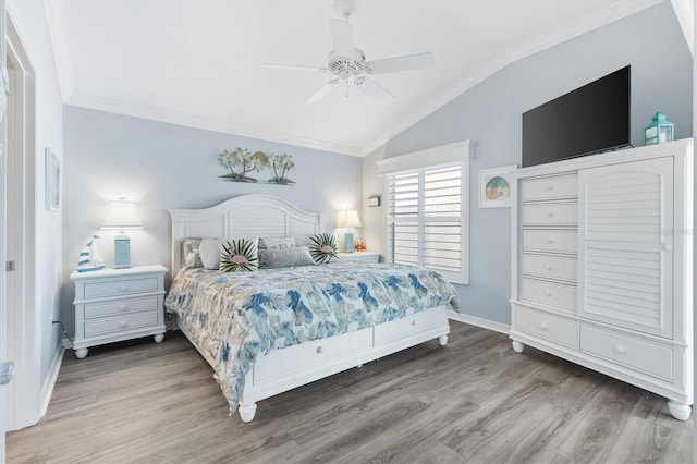 bedroom featuring ceiling fan, ornamental molding, lofted ceiling, and hardwood / wood-style flooring