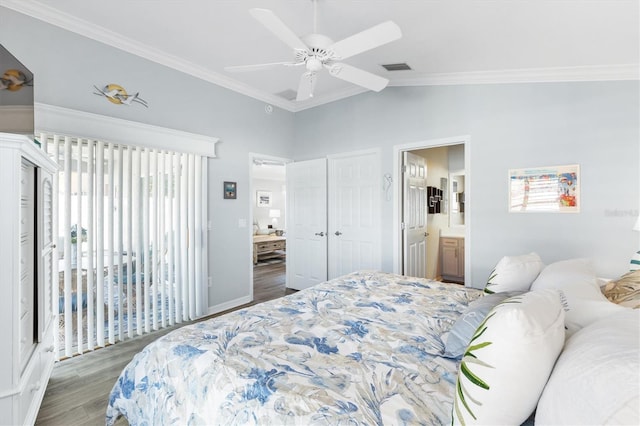 bedroom with dark wood-type flooring, vaulted ceiling, ceiling fan, ornamental molding, and connected bathroom