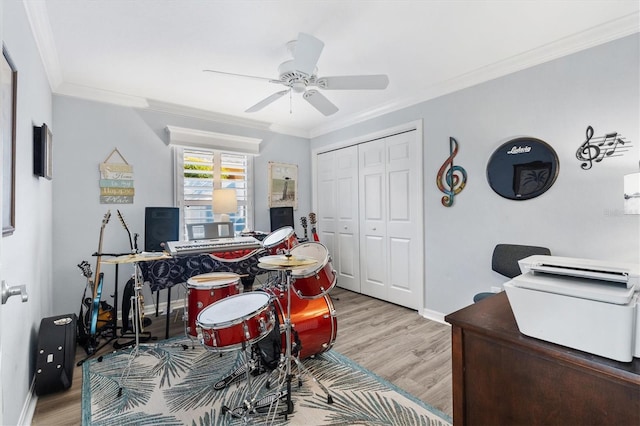 office with ceiling fan, ornamental molding, and light hardwood / wood-style flooring