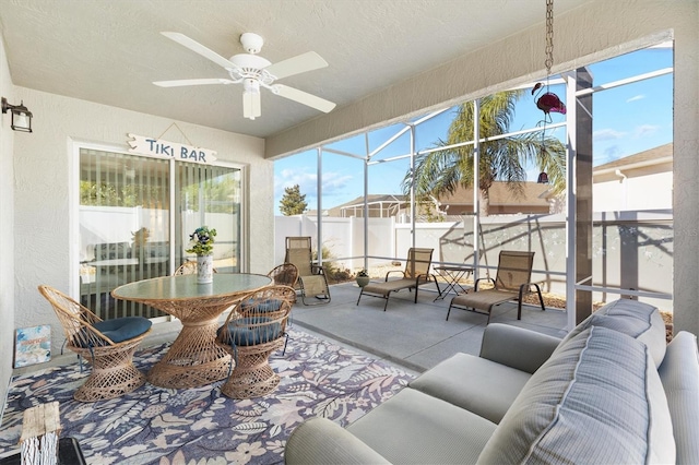 sunroom with a wealth of natural light and ceiling fan