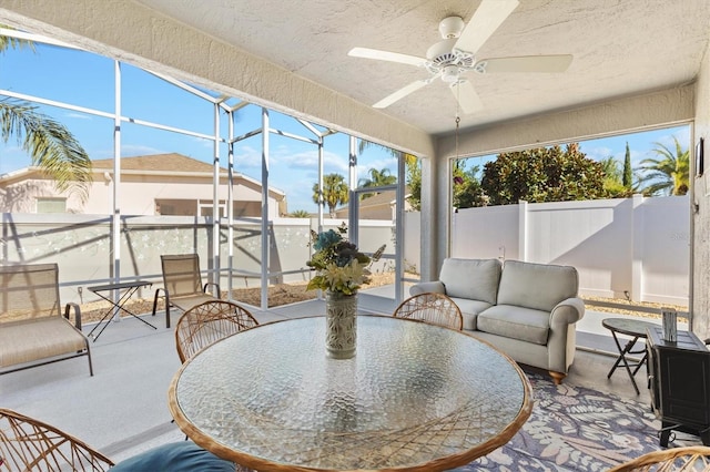 sunroom / solarium featuring ceiling fan