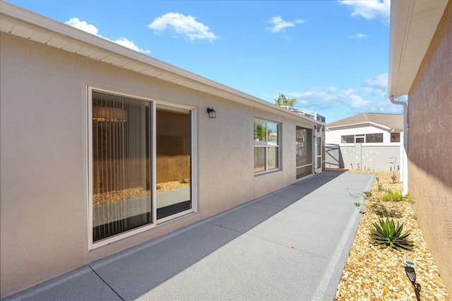 view of side of property with a patio area