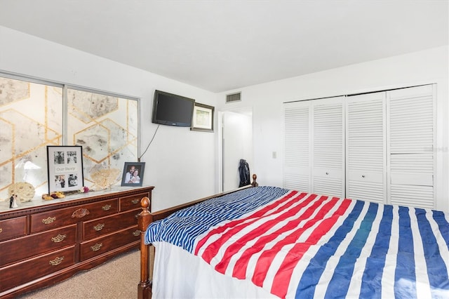 bedroom with a closet and light colored carpet