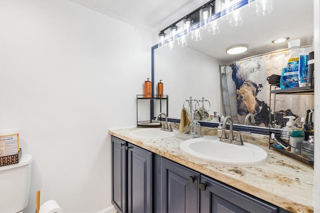 bathroom featuring a shower with curtain, vanity, and toilet