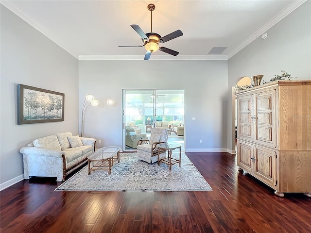 living room with crown molding, ceiling fan, and dark hardwood / wood-style floors