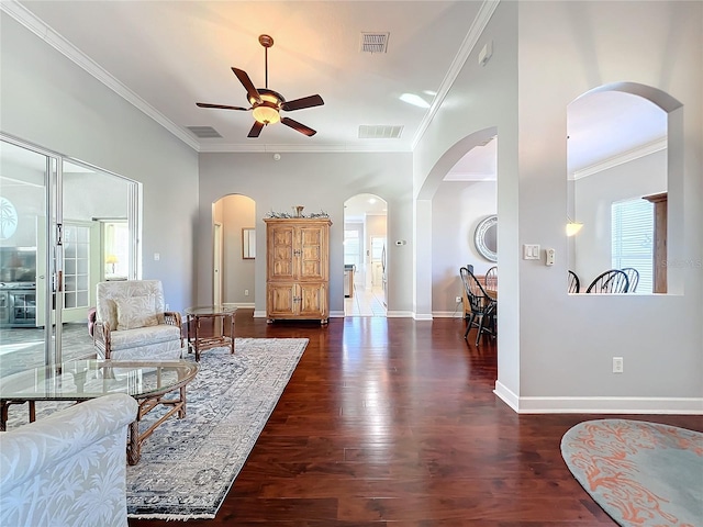 living room with crown molding, a wealth of natural light, dark wood-type flooring, and ceiling fan